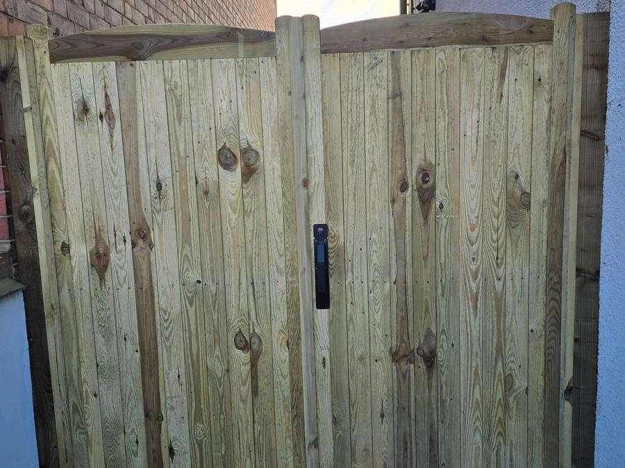 Arched-top timber driveway gate pair