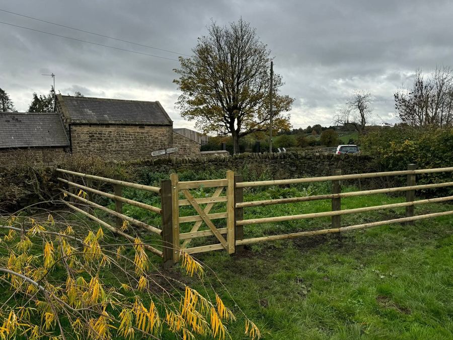 Five-bar timber field gate with post-and-rail fencing