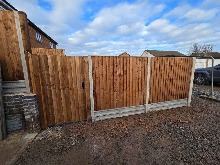 Closeboard gate within a matching fence run